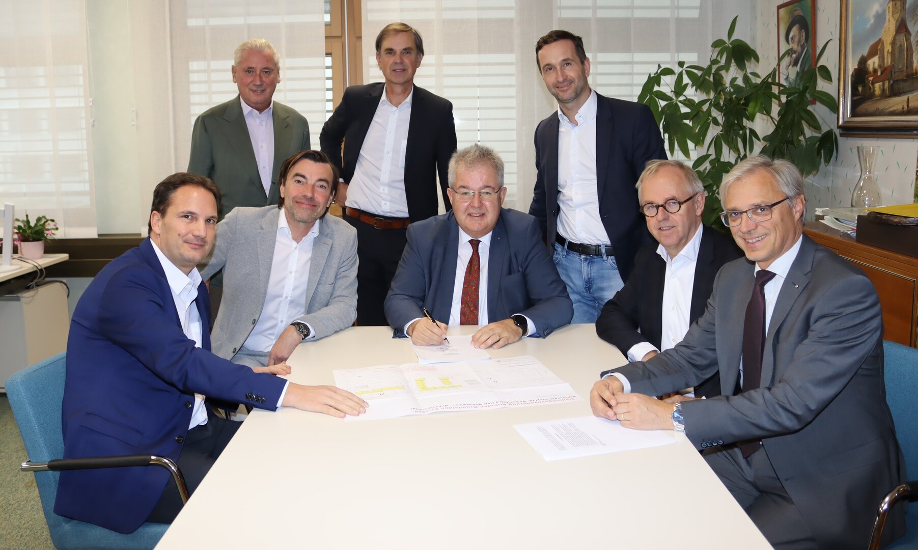 Mathias Moser, Christian Rädler, Bürgermeister Walter Zemrosser, Manfred Schaufler, Notar Christian Perchtold (von links vorne), Josef Panis, Stadtamtsleiter Hubert Madrian und Vize-Bürgermeister Michael Baumgartner (von links hinten) Vertragsunterzeichnung.jpg